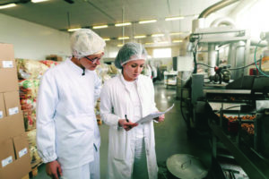 Photo of an assessor auditing a food business. 