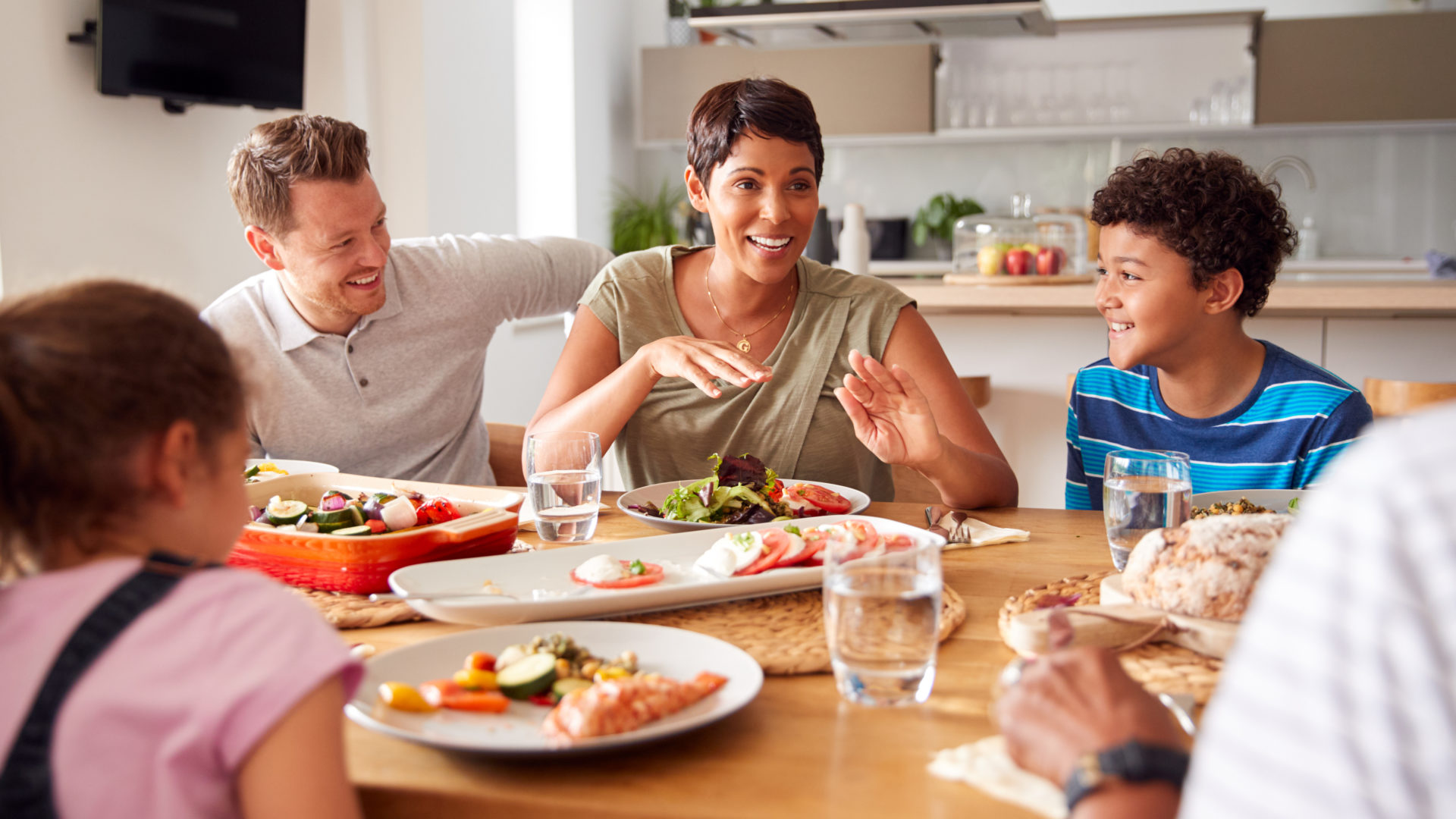 Multi-generation,Mixed,Race,Family,Eating,Meal,Around,Table,At,Home