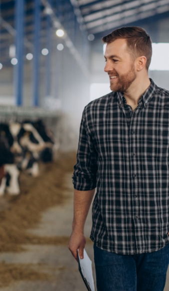 Farmer in a cow shed